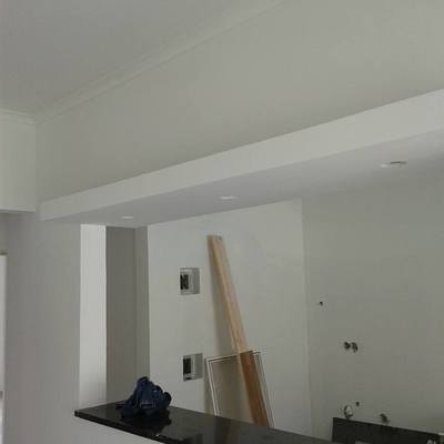 Construção de uma cozinha com ilha,um pequeno balcão com focos.